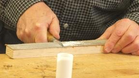 Image of Woodcarver Harley Refsal sharpens knife