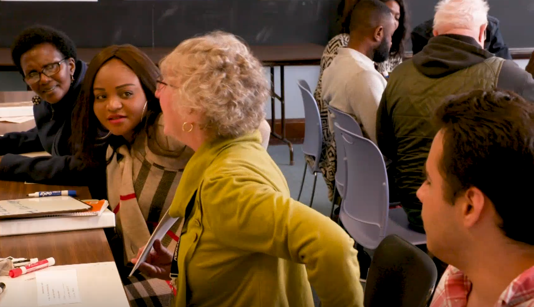 Adult students practice reading in the classroom.