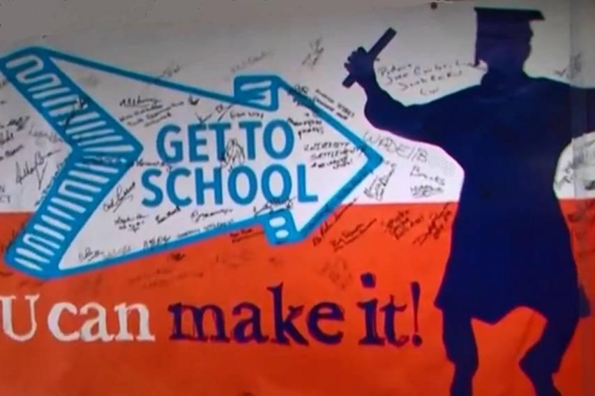 A mural states: "Get to school. U can make it!"