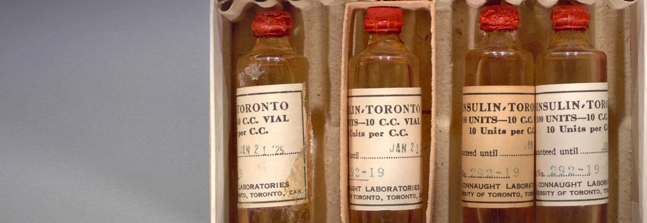 An historical photograph from 1925 of 4 bottle of insulin packed in cardboard