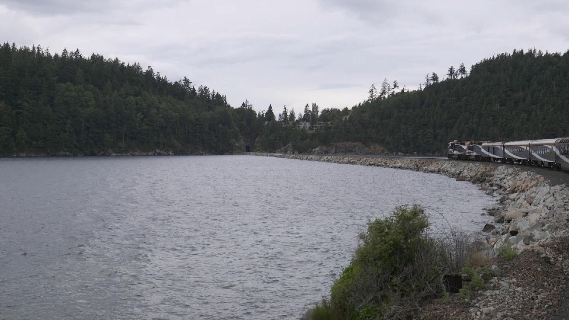 Train meanders along waters edge 