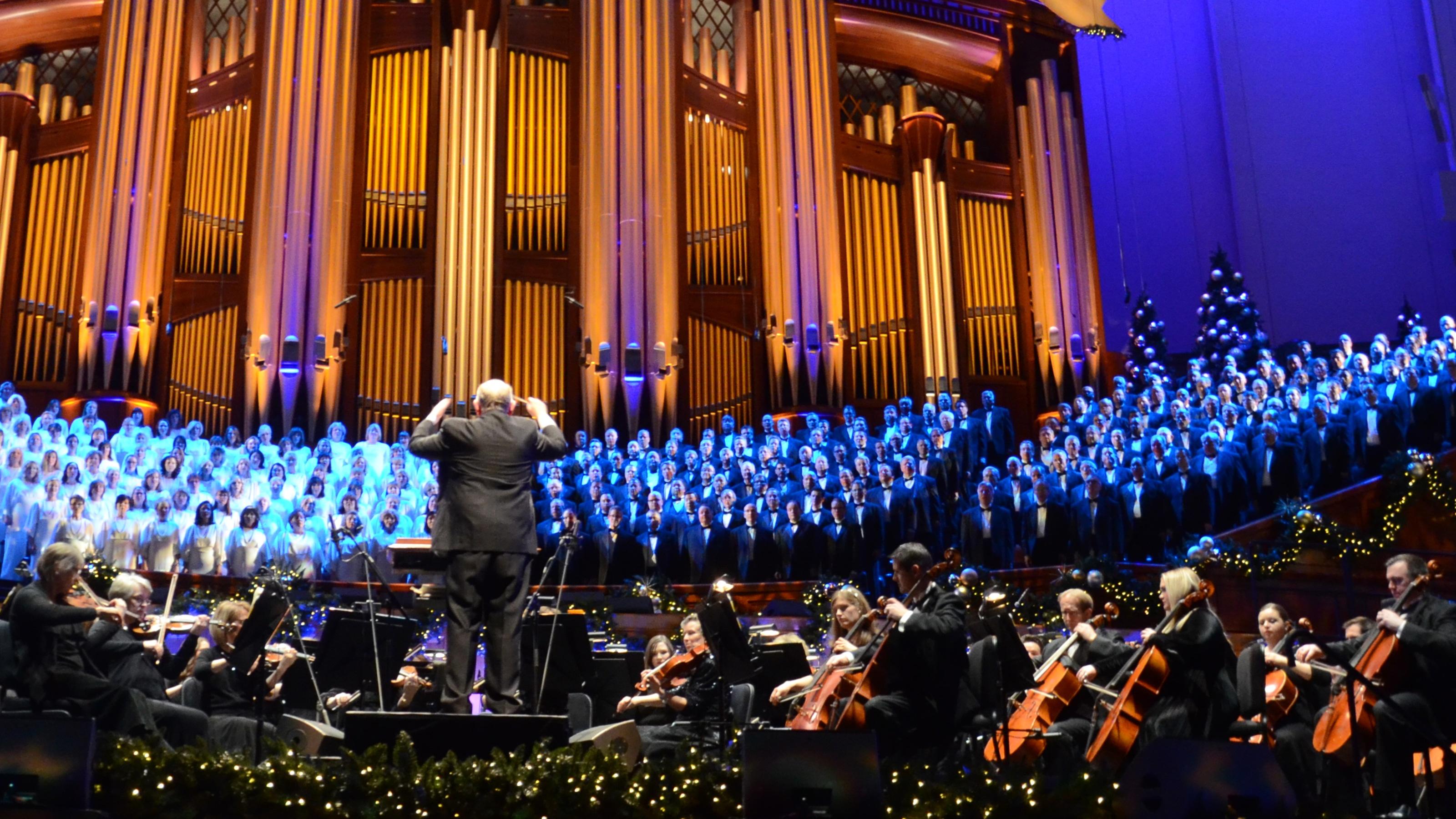 With the large organ in the background, Mack Wilberg stands among The Orchestra at Temple Square and The Tabernacle Choir.