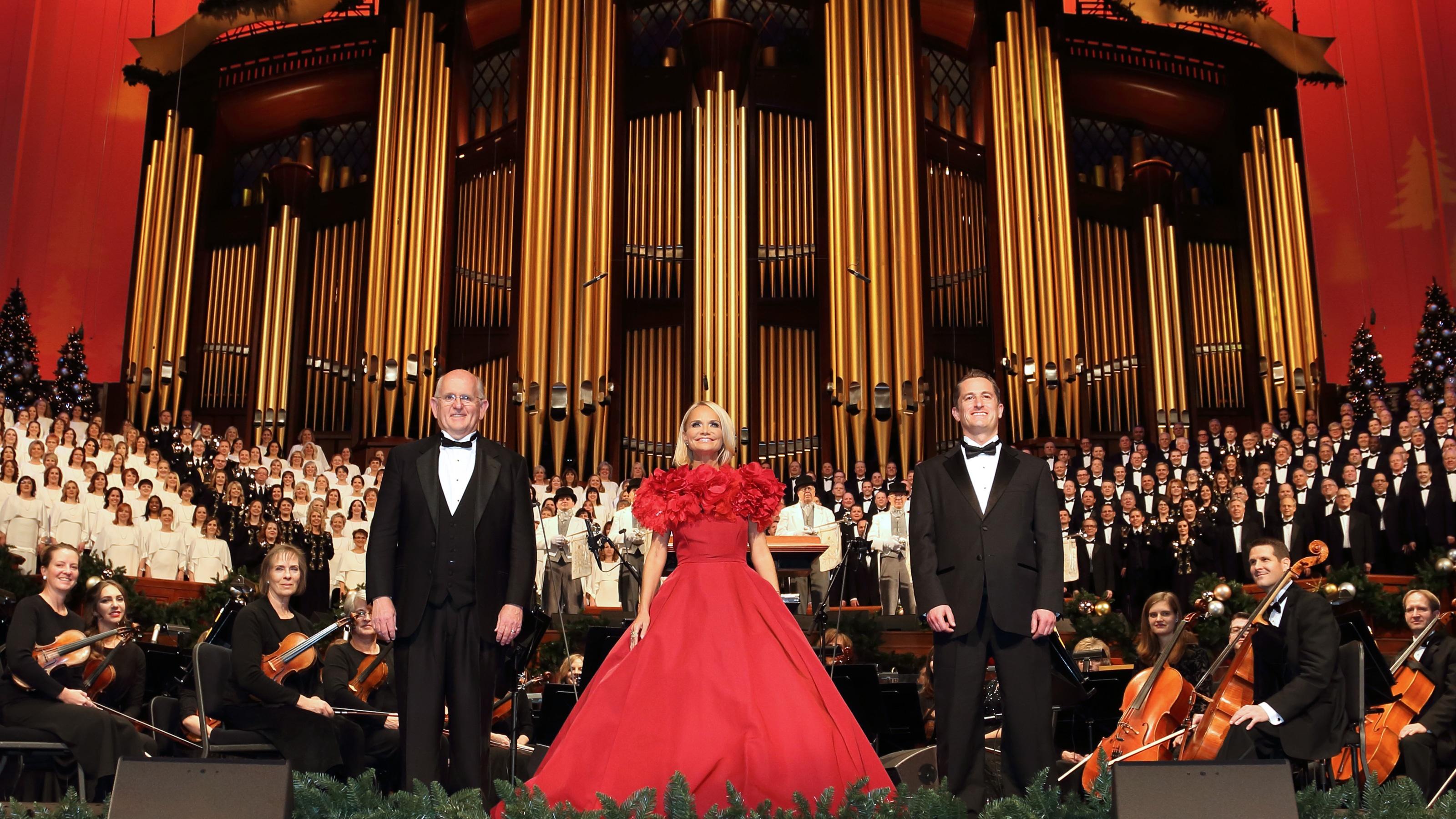 Mack Wilberg, Kristin Chenoweth and Ryan Murphy stand center stage with The Orchestra at Temple Square and The Tabernacle Choir behind them.