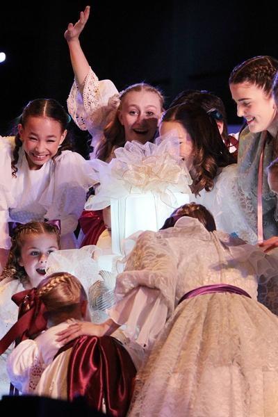 Smiling and laughing, children sing Gift of Christmas, Everywhere!