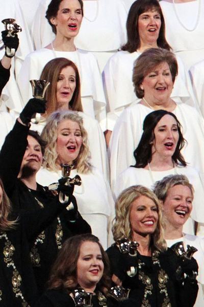The Tabernacle Choir sings Fill the World with Love while musicians in black suits accompany them on bells.