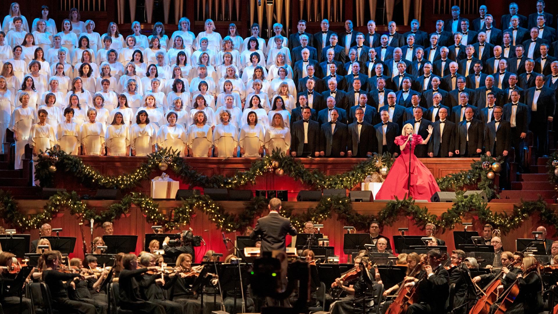 Kristin Chenoweth singing with the Tabernacle Choir behind her and the Orchestra at Temple Square in front of her.