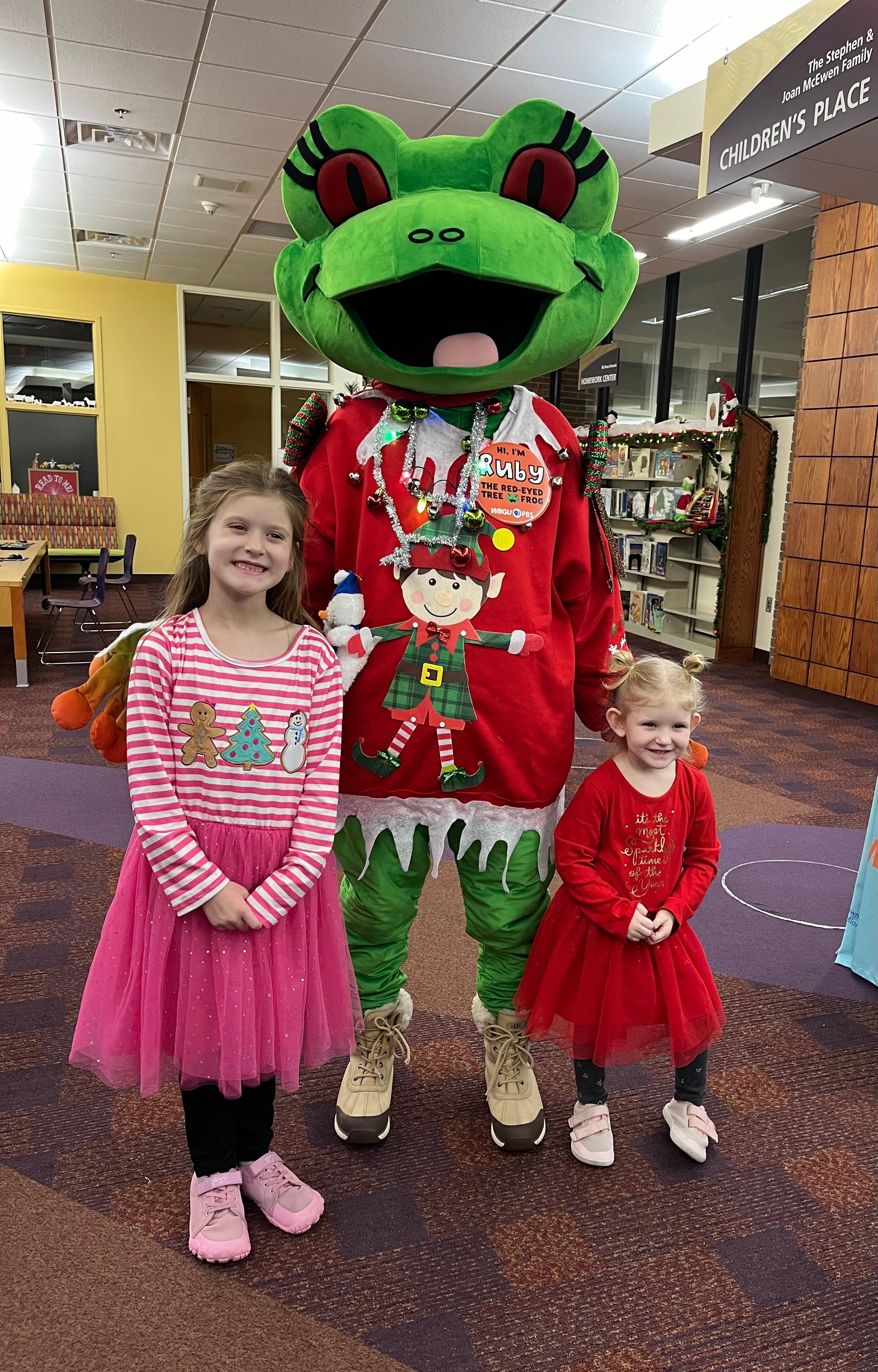 Ruby posed standing next to two girls.