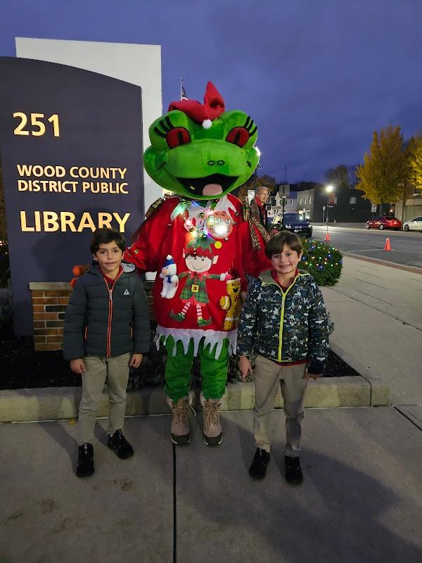 Ruby posed next to two boys in front of the library.