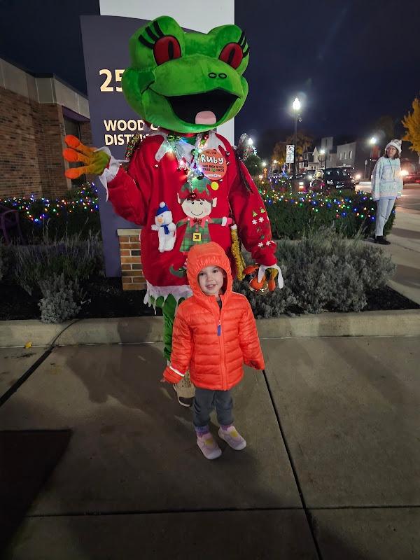 Ruby Standing behind while posing with a girl in a bright orange coat.