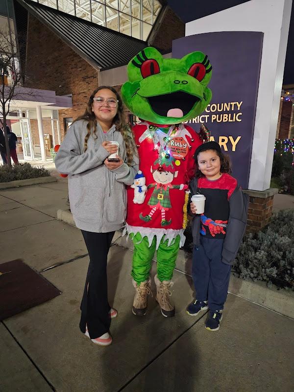 Two girls posed next to Ruby in front of the Wood County District Public Library