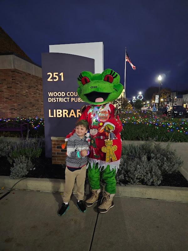 Ruby posed beside a boy wearing two glowing wristbands.