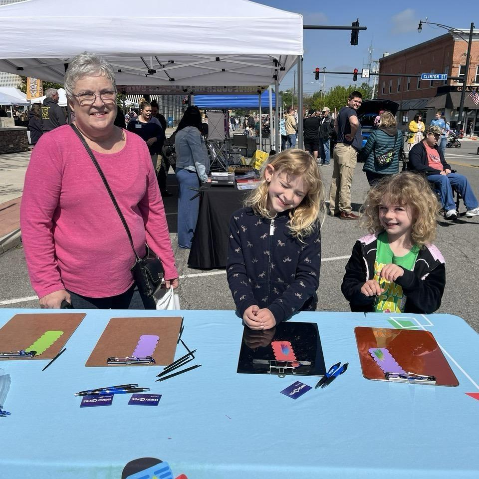 Family enjoys working on a Magic Scratch Craft at the Defiance Lilac Festival on May 9, 2026