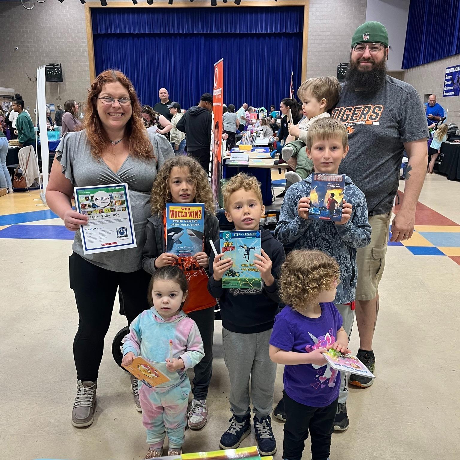 April 25, 2026 - Family holds INFOhio BookFlix Flyer and Books they received at the Wood Co. Family & Children First Council's Spring Fling Event at Elmwood High School in Wood County, Ohio. 