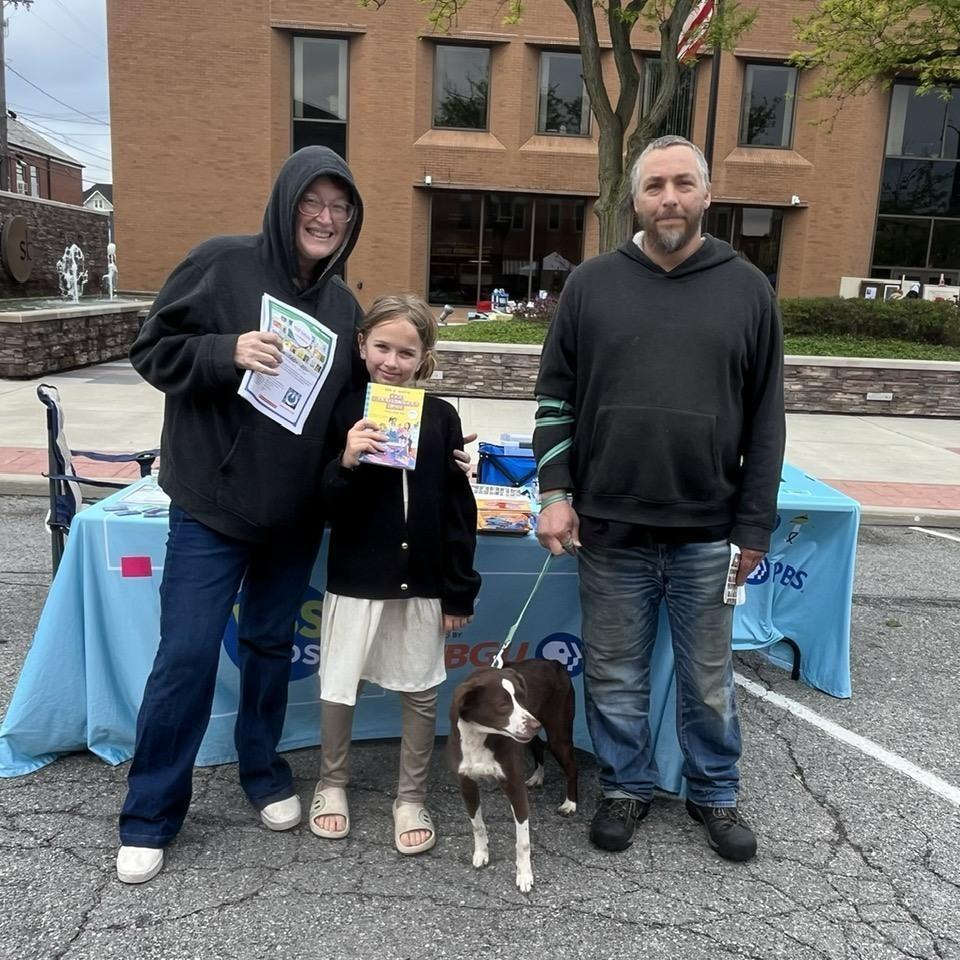 May 9, 2026 - A family holds an INFOhio BookFlix Flyer and children's books they received at the Defiance Lilac Festival in Defiance, Ohio. 