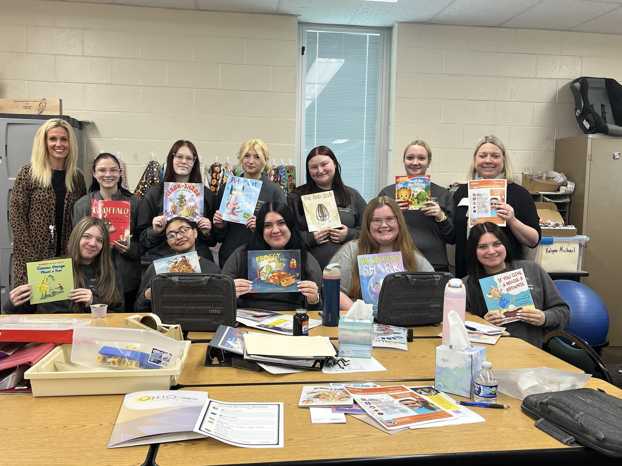Mrs. Cathy Meyer’s Early Childhood Education class at Four County Career Center holds children's books they received during the INFOhio professional development session on April 29, 2026.