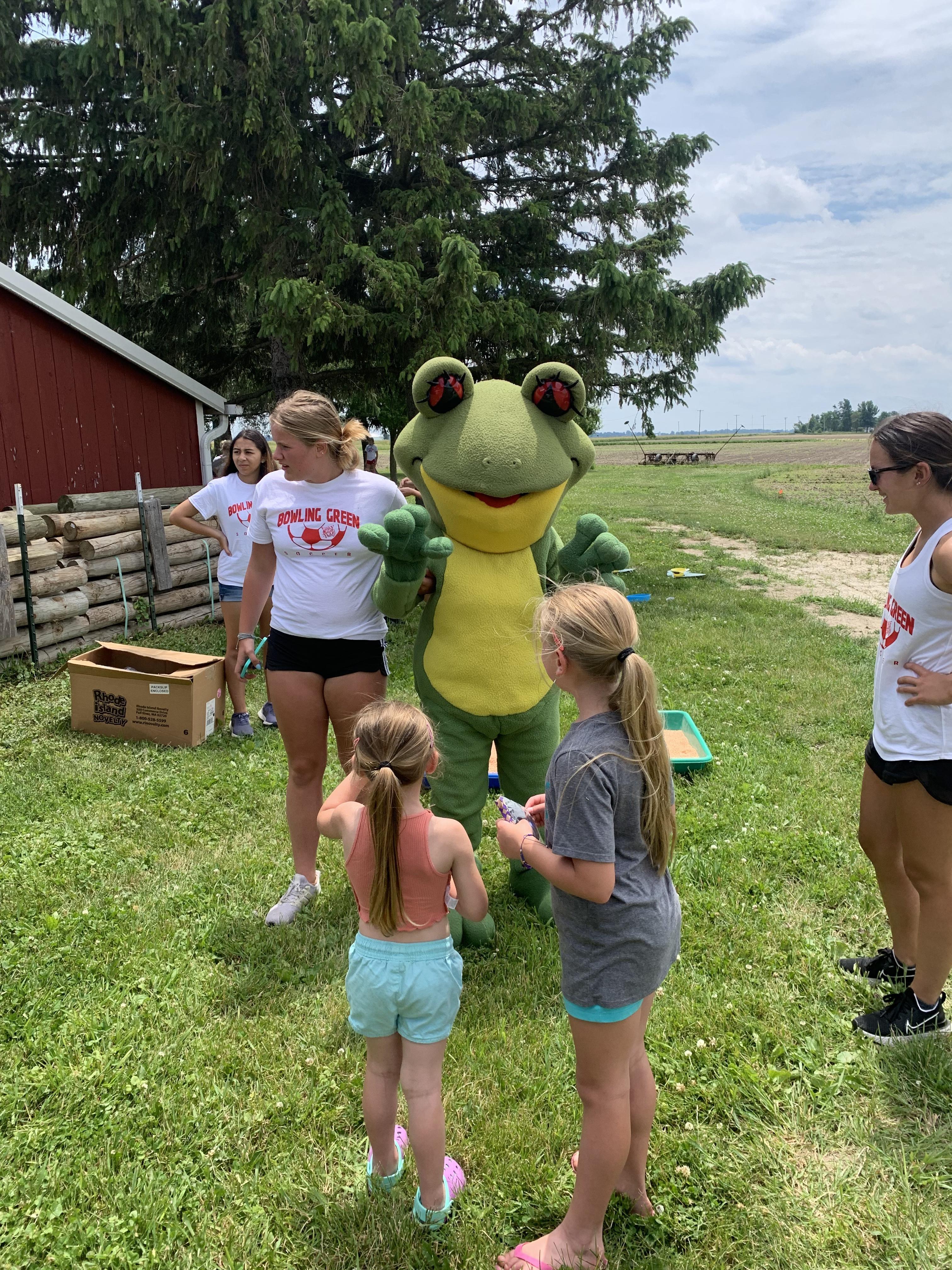 kids with Ruby the Red Eyed Tree Frog mascot