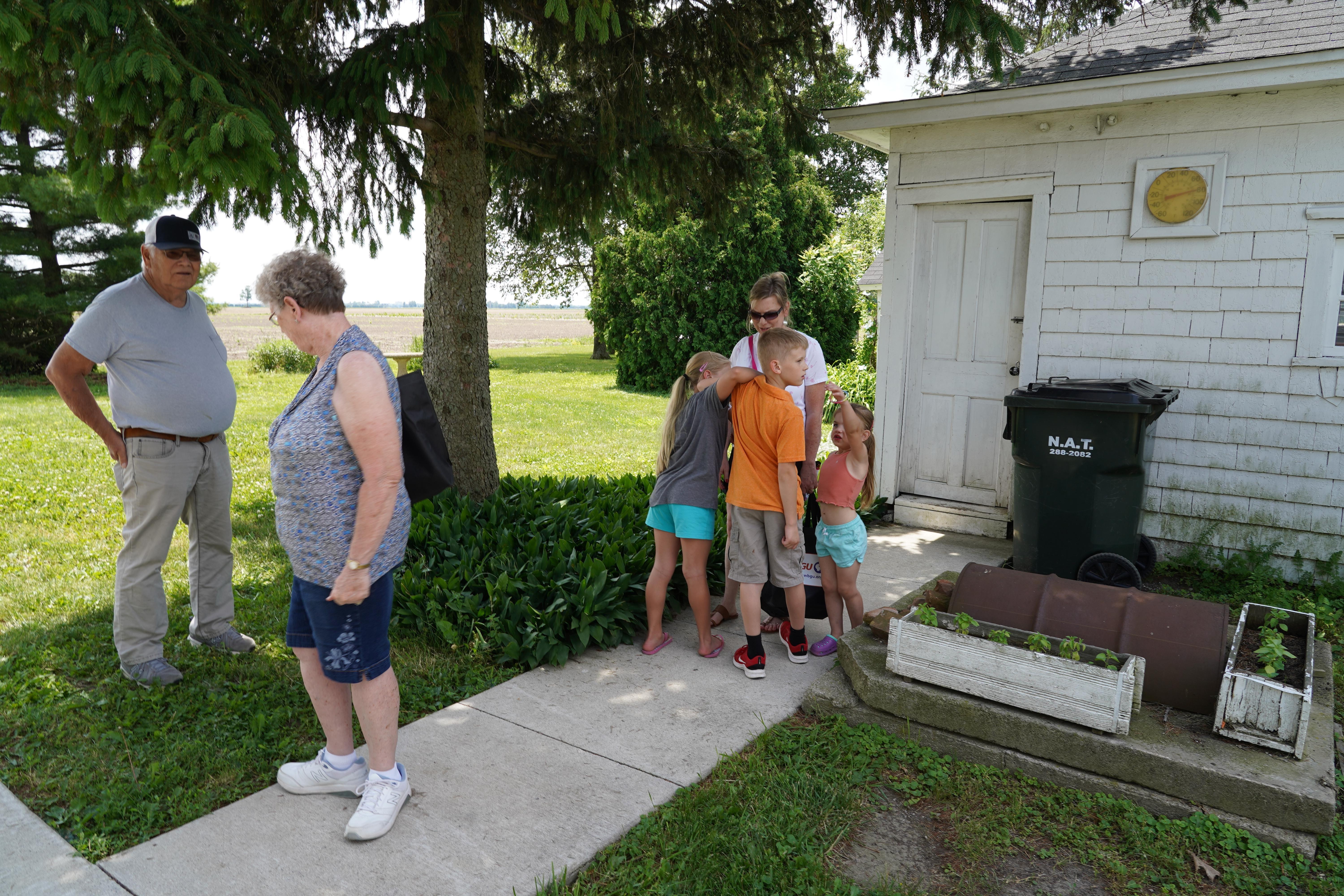 patrons outside farm house