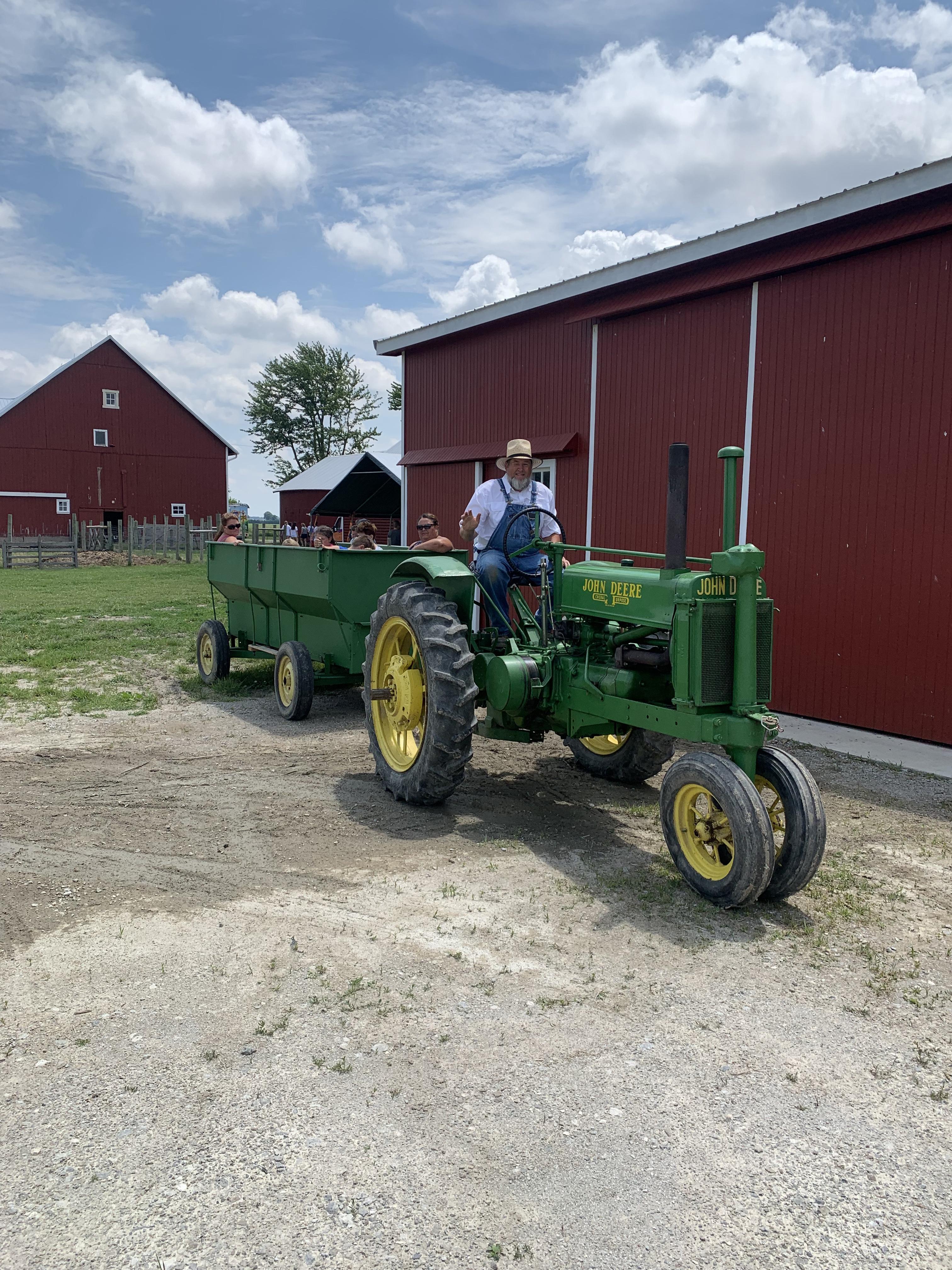 farmer on tractor pulling trailer