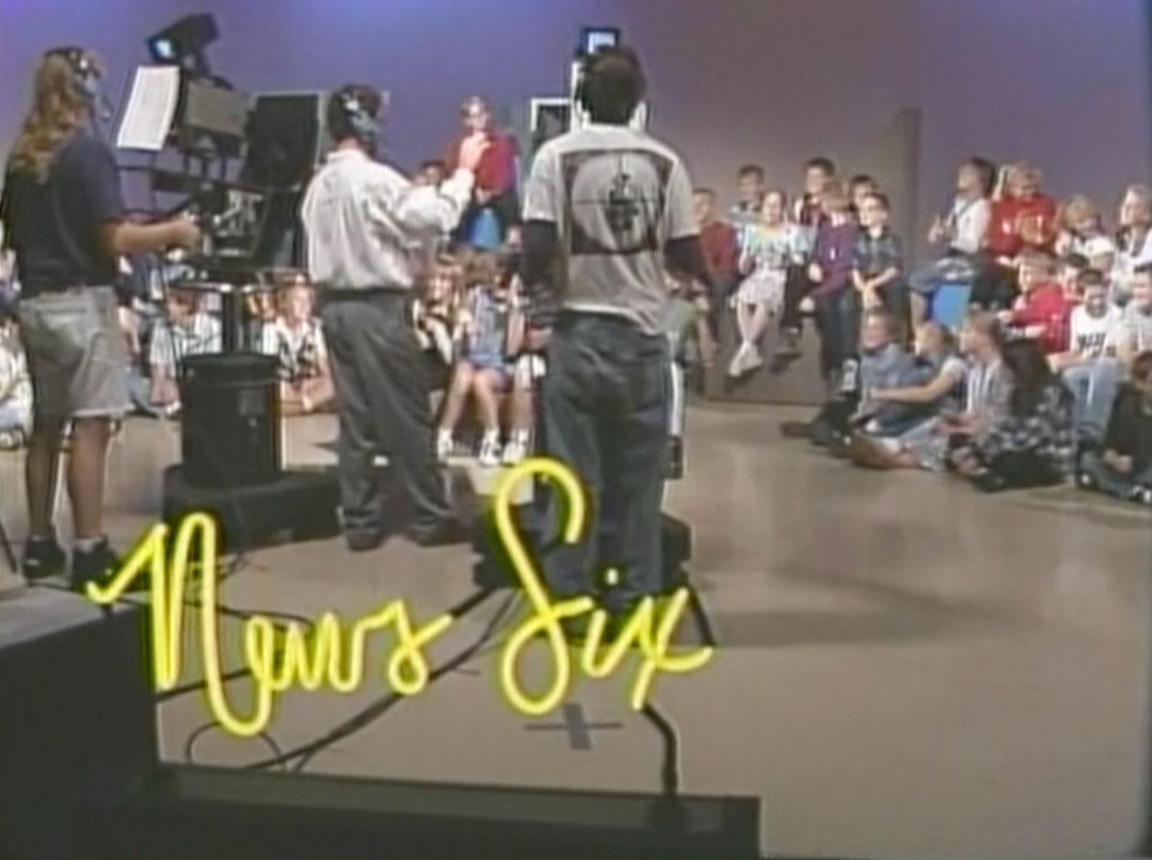 tv studio scene with news six text