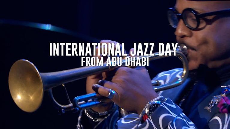 A close-up shot of a musician in glasses playing a trumpet, with text that reads "INTERNATIONAL JAZZ DAY FROM ABU DHABI."