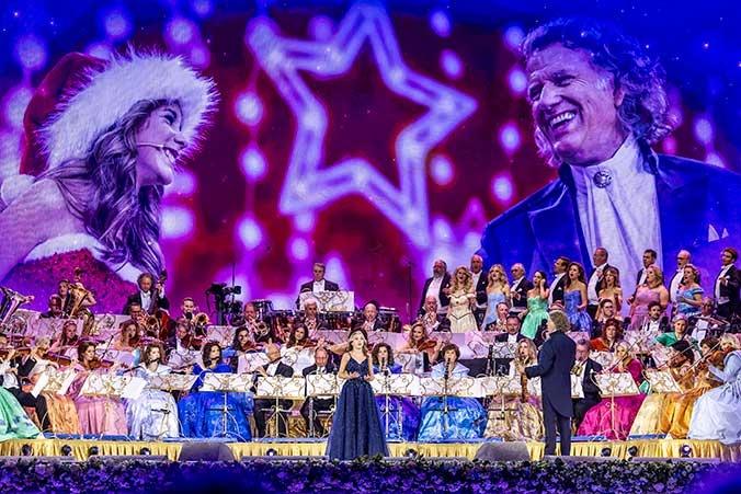 The image captures a live performance by Dutch violinist and conductor André Rieu and his Johann Strauss Orchestra. 