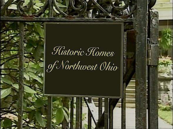 Image is of a black iron gate with a black rectangular sign that reads “Historic Homes of Northwest Ohio.”