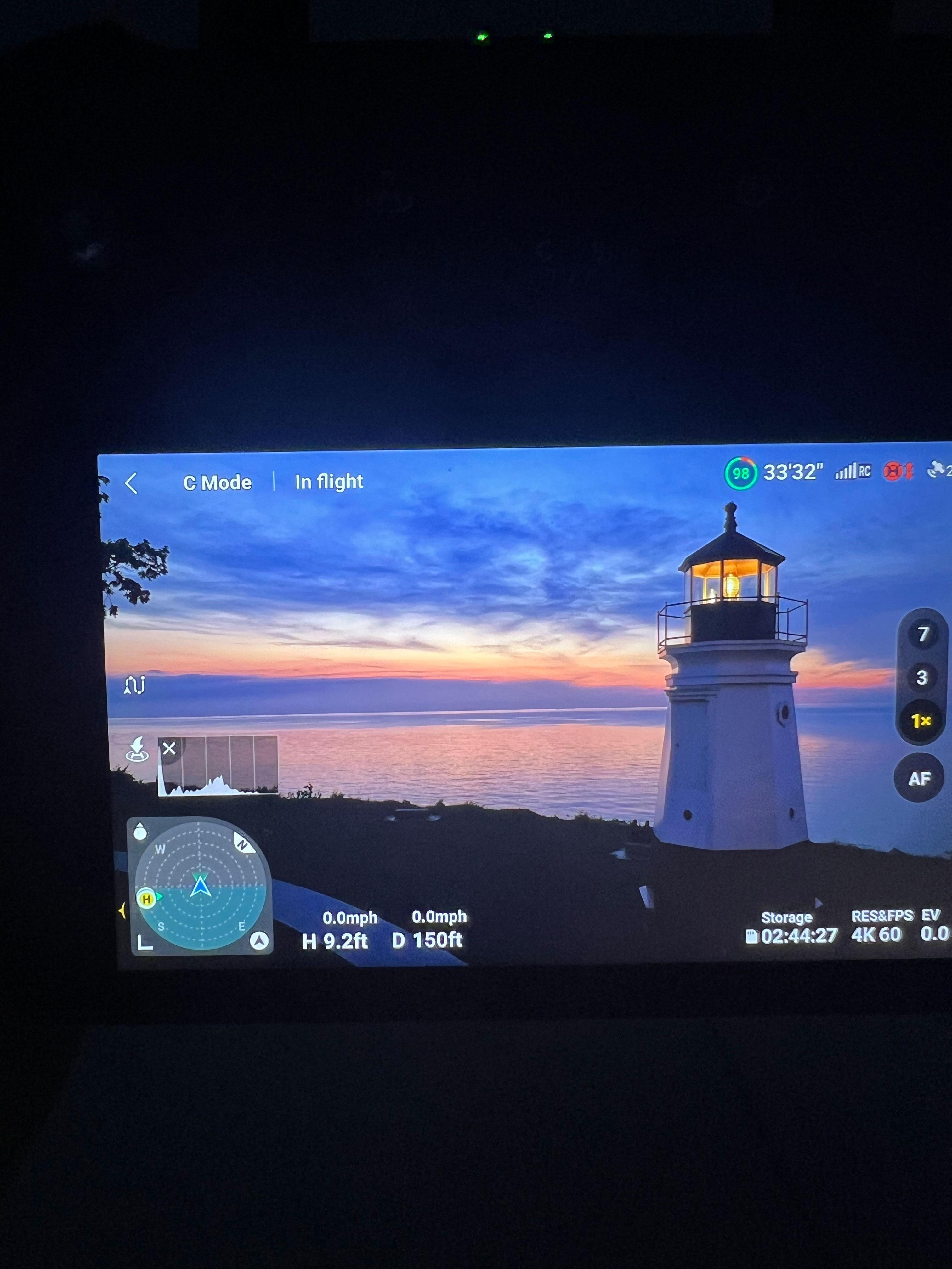 Drone viewfinder showing Vermilion lighthouse at sunset