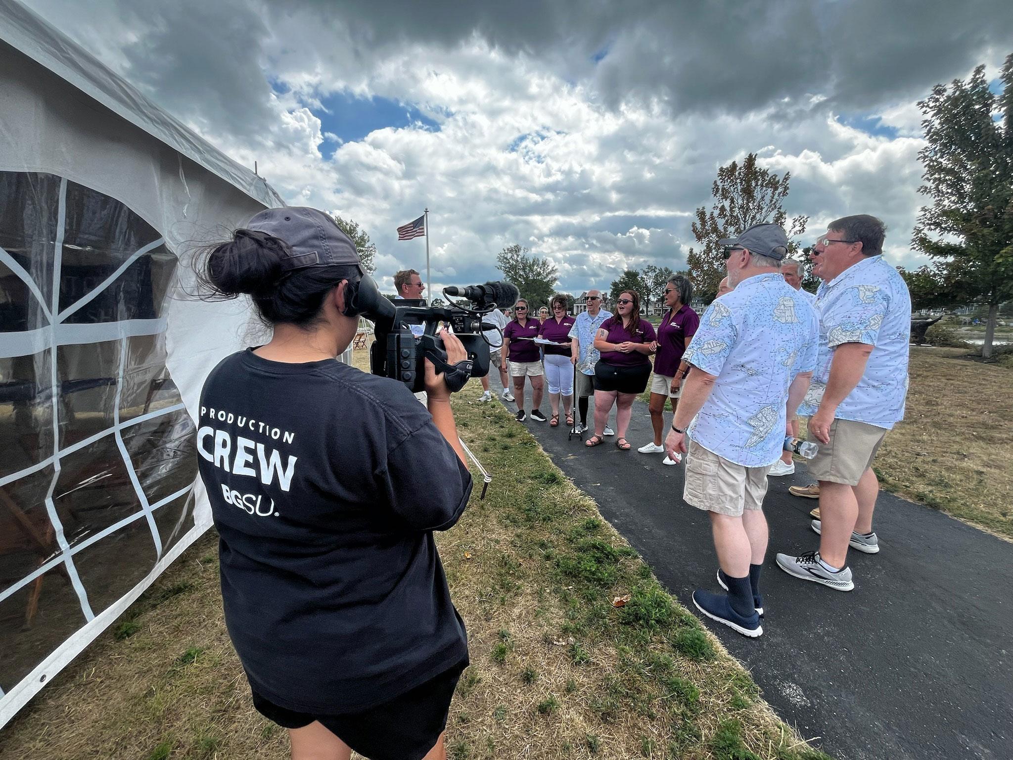 Sylvia Torres shooting video of visitors outside Port Clinton Lighthouse