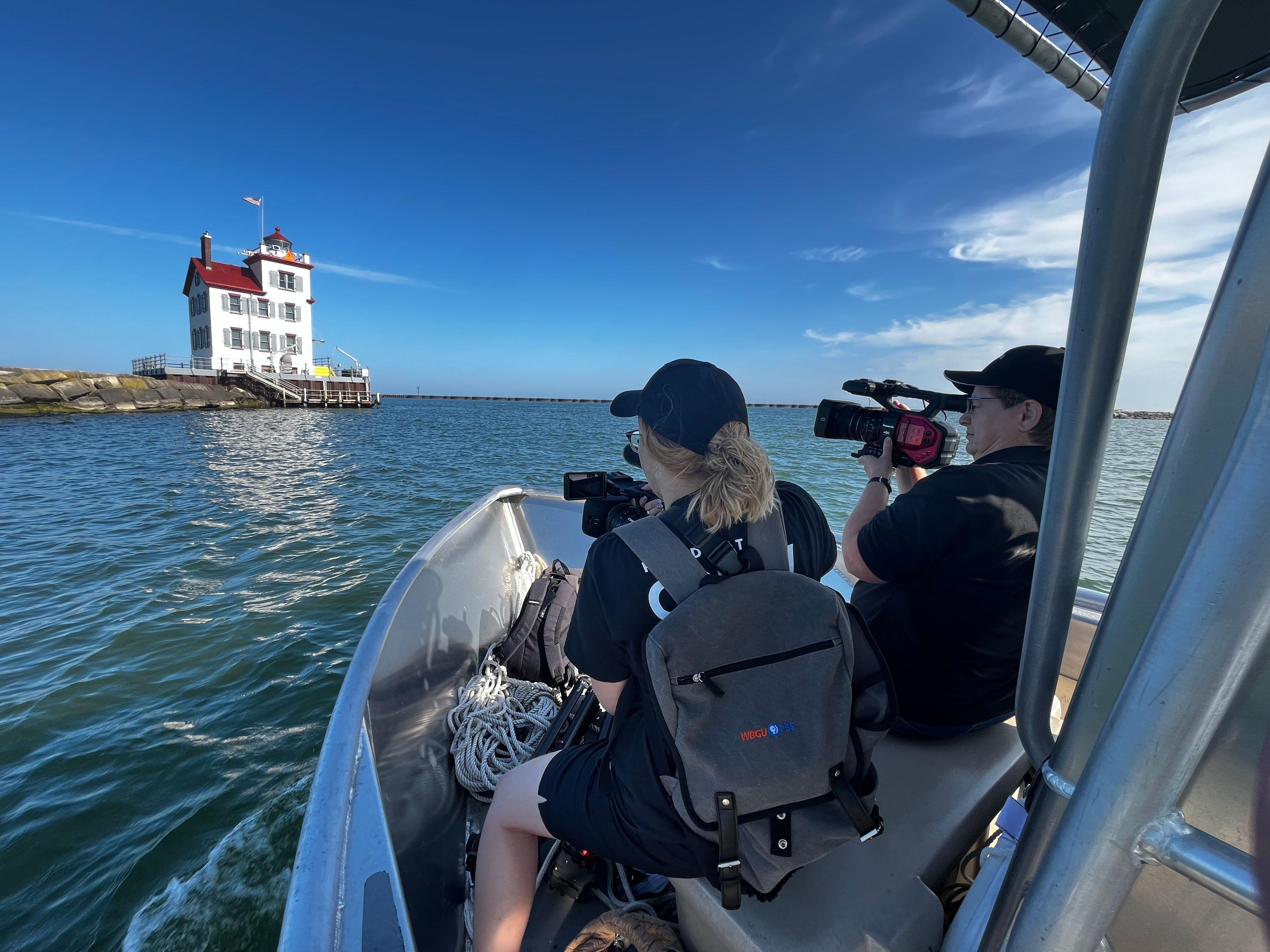 Crew on a boat taking video of Lorain Lighthouse