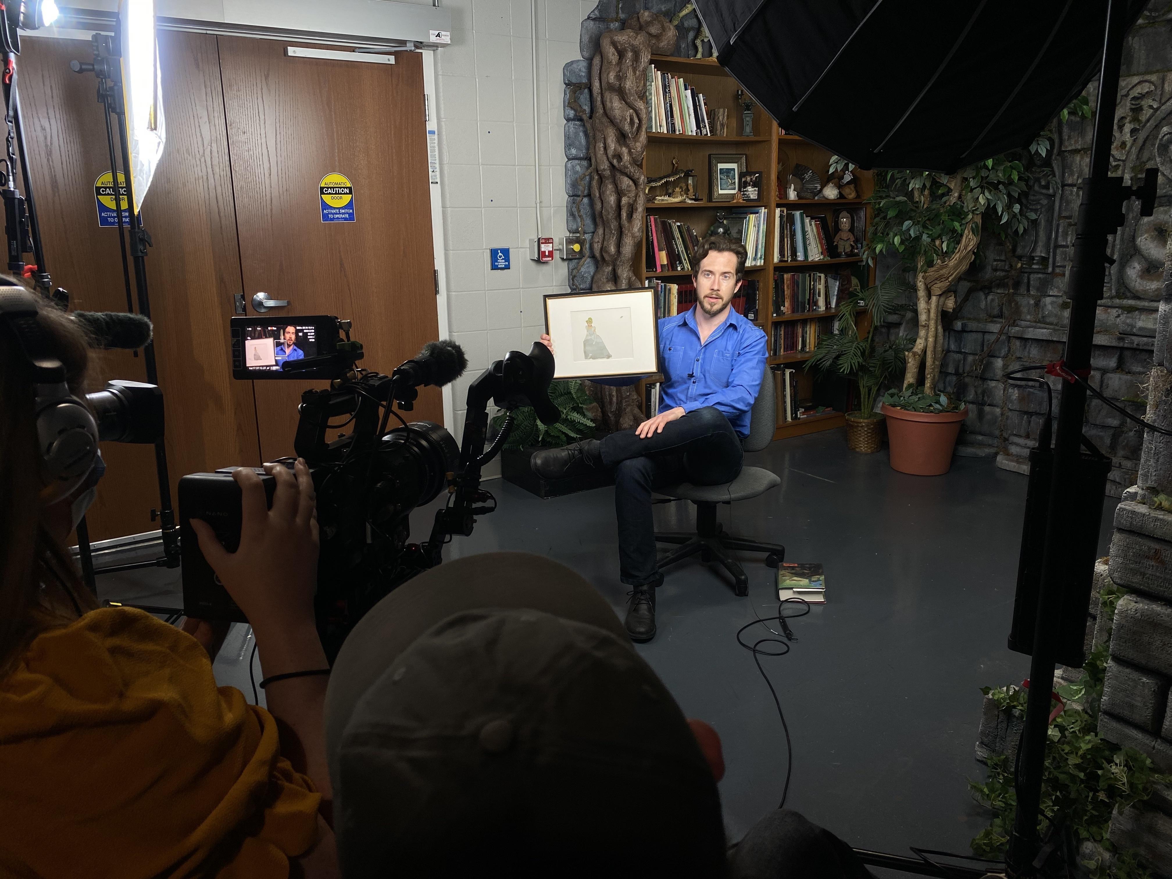 interview scene with subject holding framed picture