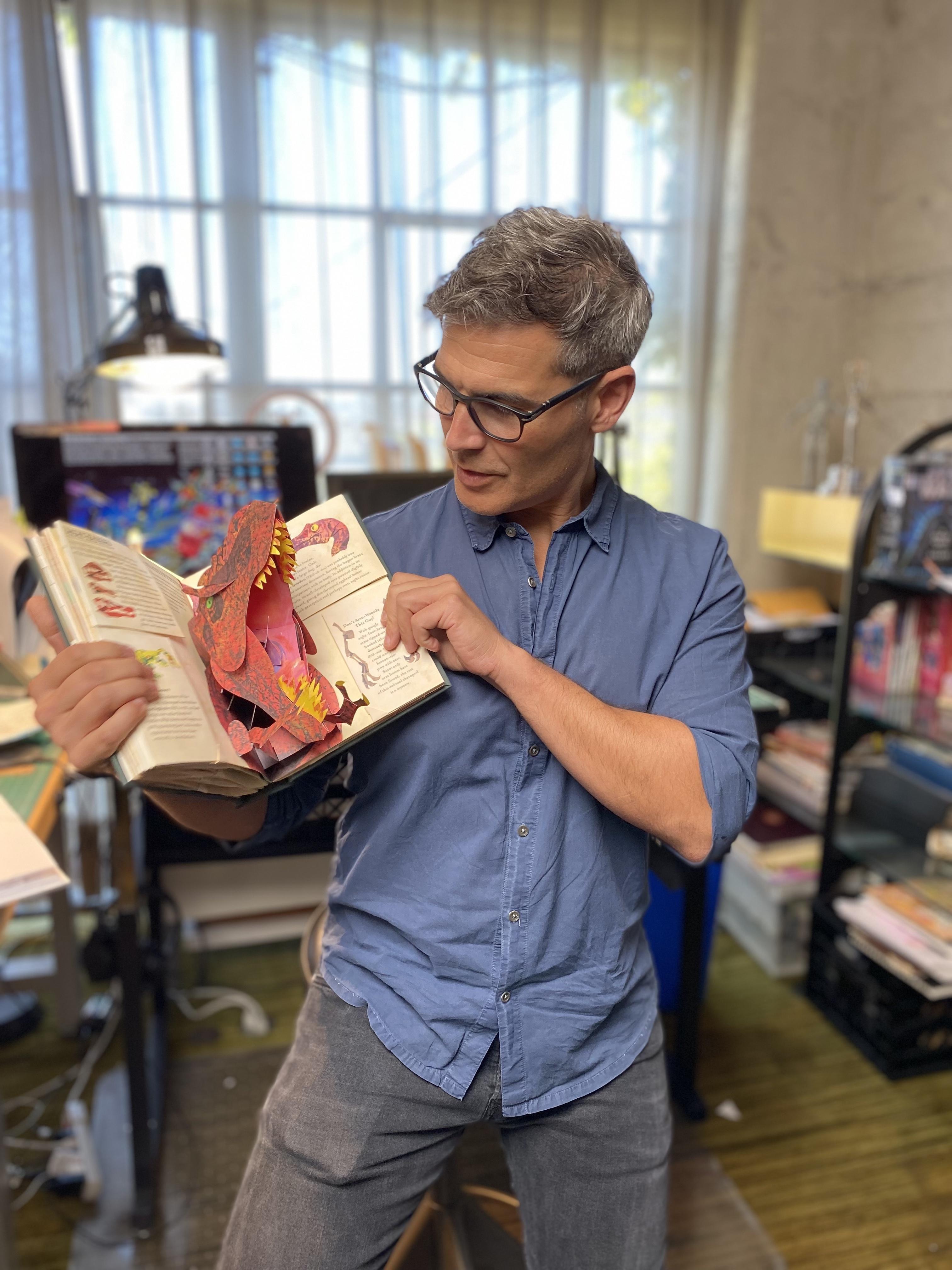 illustrator holding book