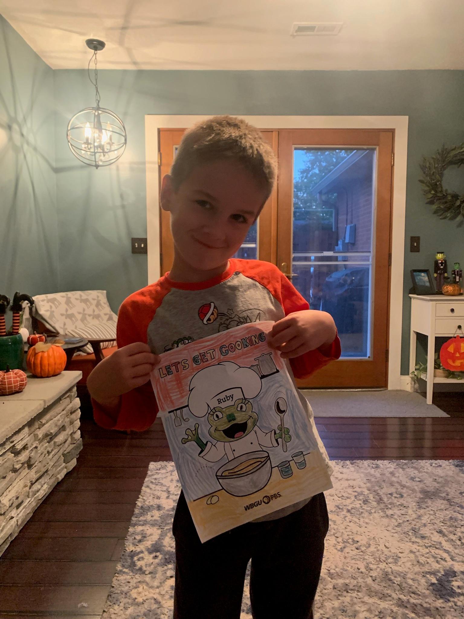 Boy posing with coloring sheet