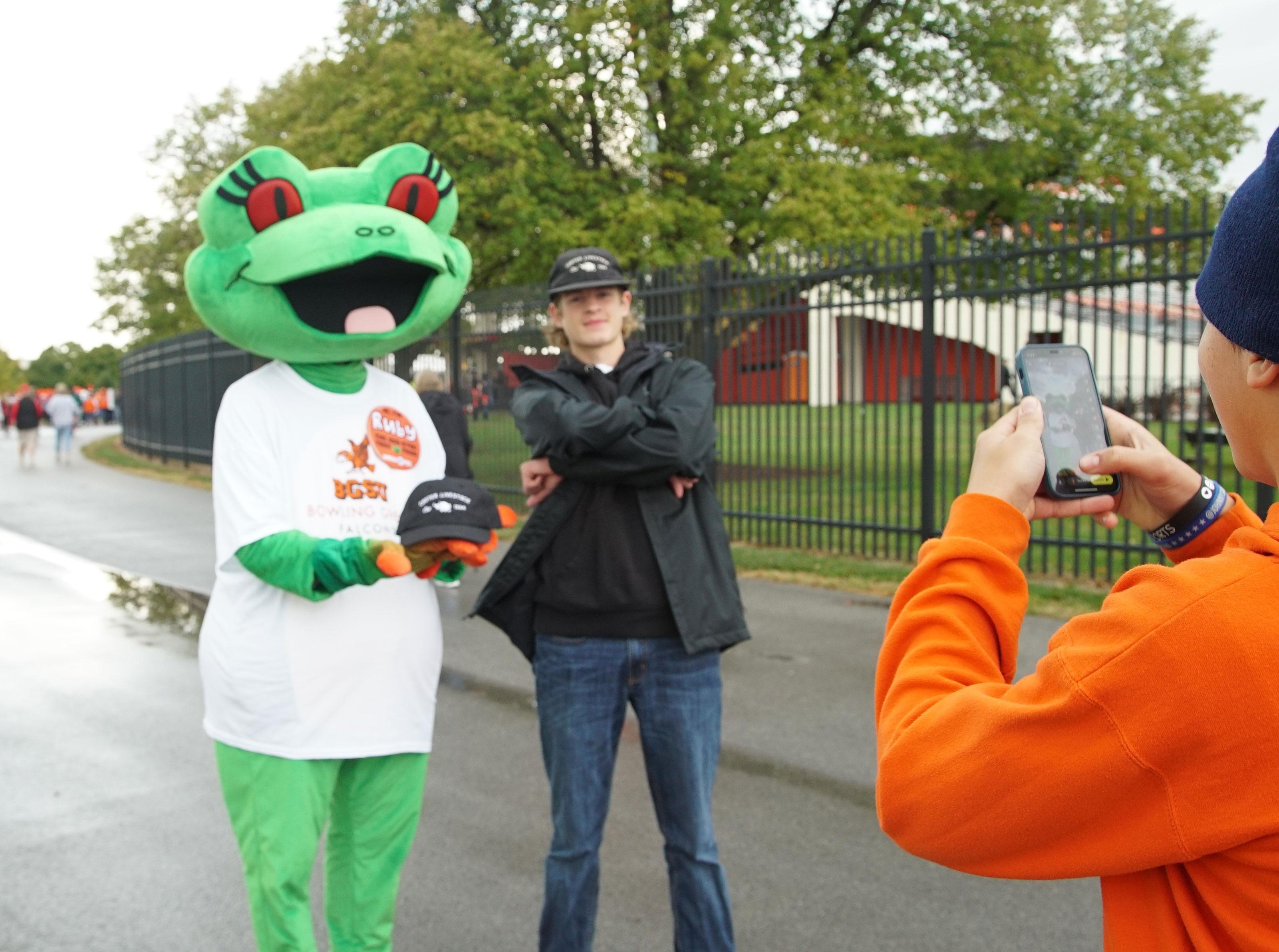 Station mascot Ruby posing with BGSU student