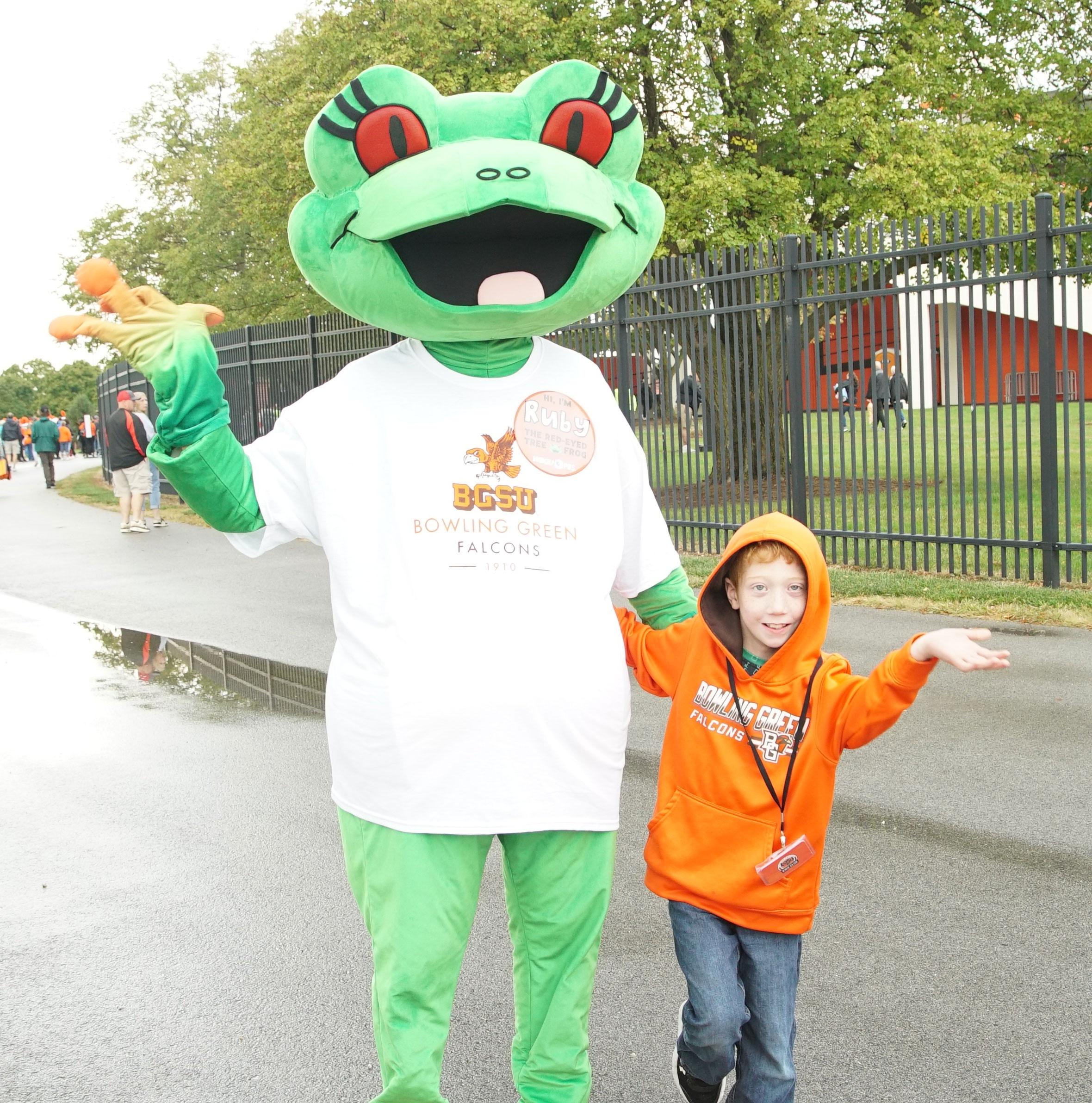 Station mascot Ruby with boy in rain