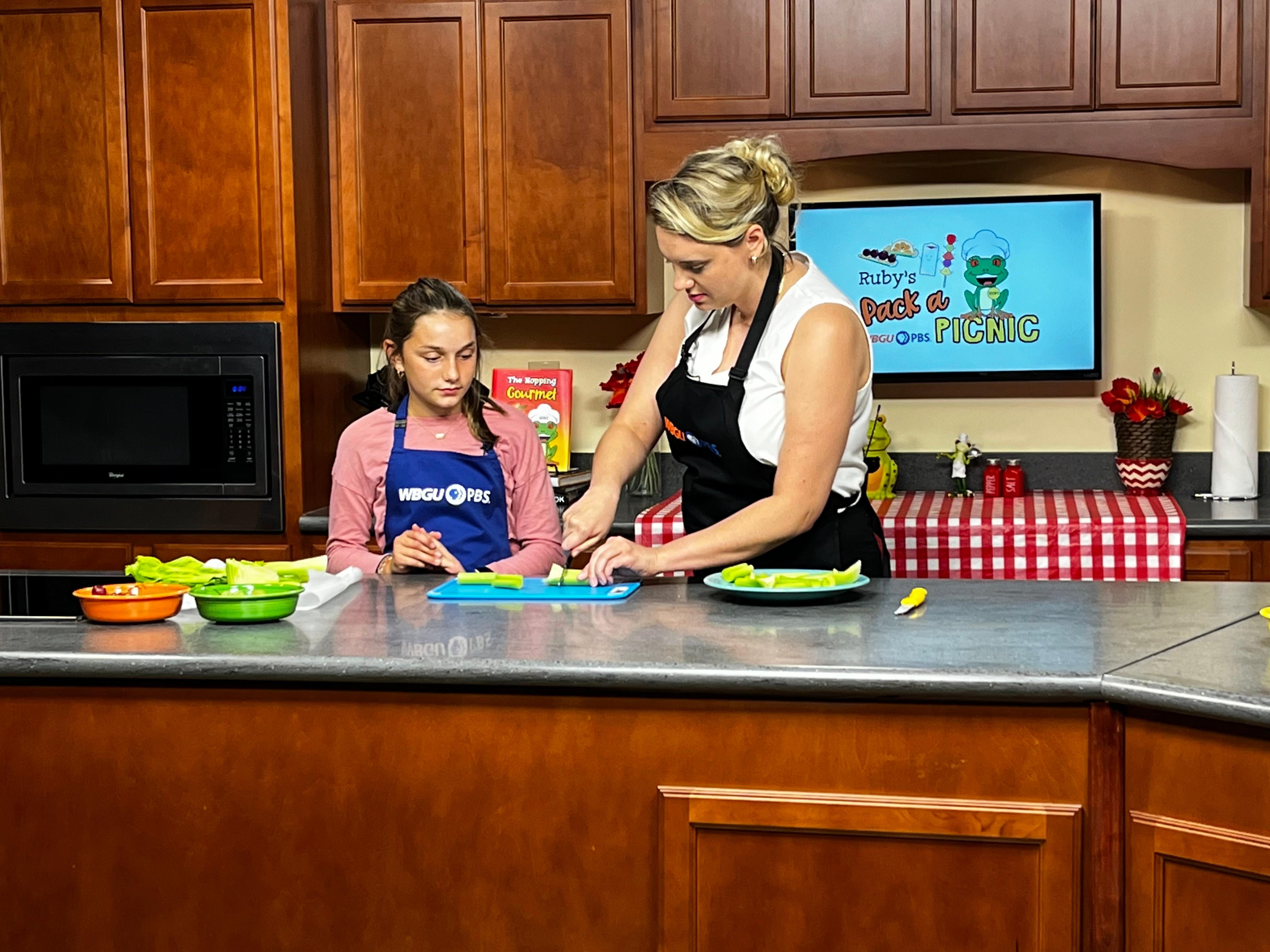 Host Kelsey Meyer with kid chef preparing celery