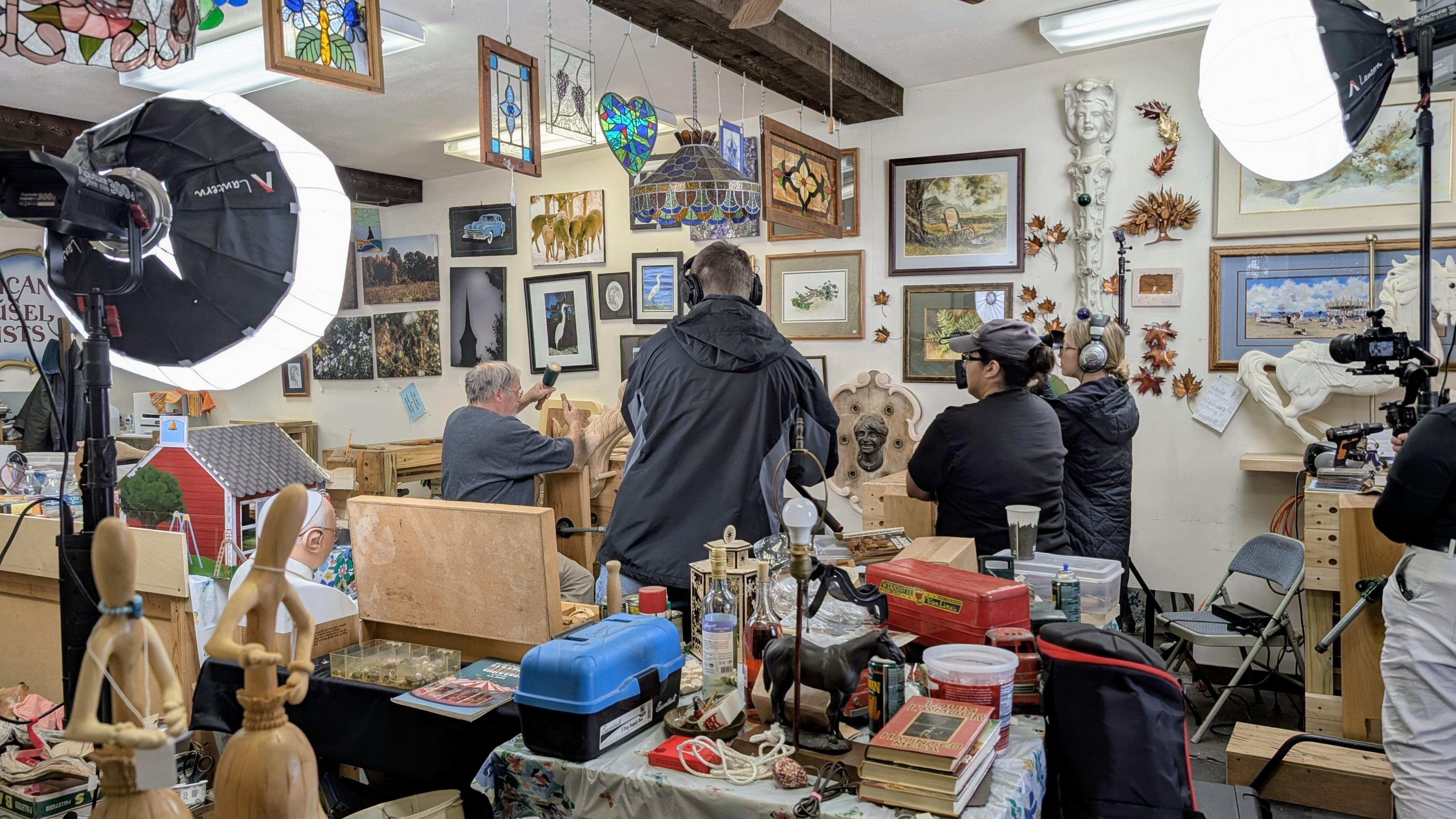 Crew working in artist's workshop