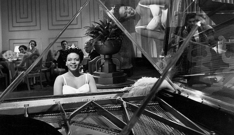 Hazel Scott playing piano in a club