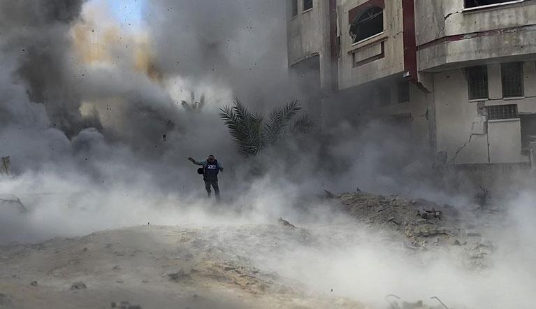 Soldier running as bombs explode