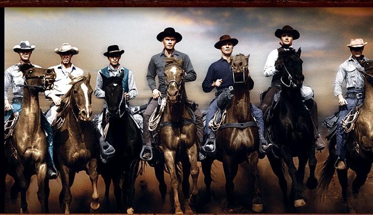 Seven cowboys riding horses