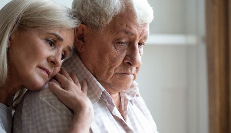 Woman hugging senior man