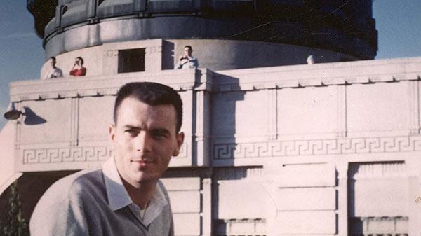 a man, Gary Flandro, in front of an observatory