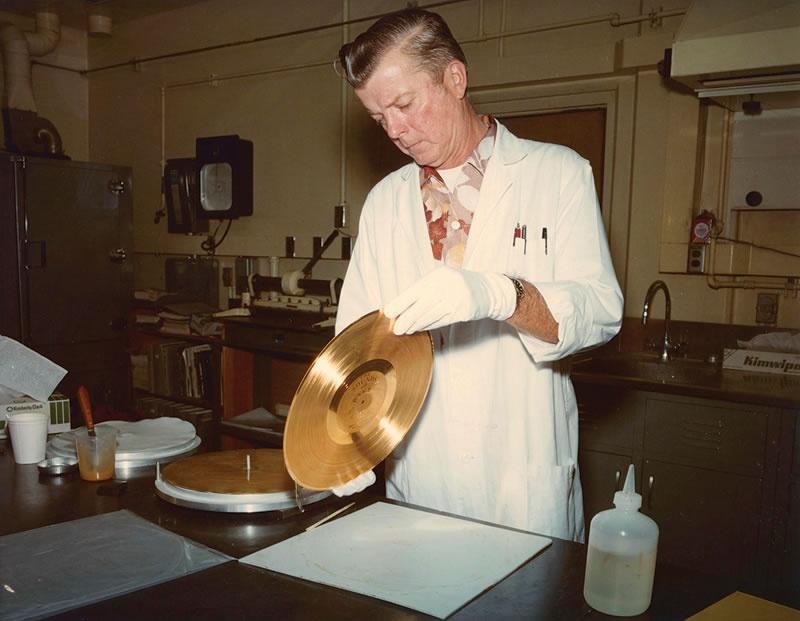 engineer holding Voyager's golden record