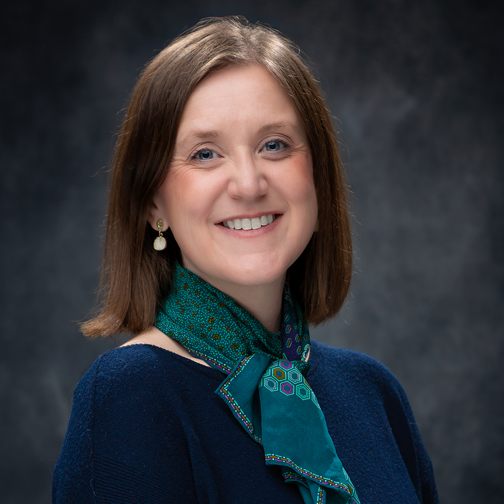Image of Melissa Davlin smiling against a gray background