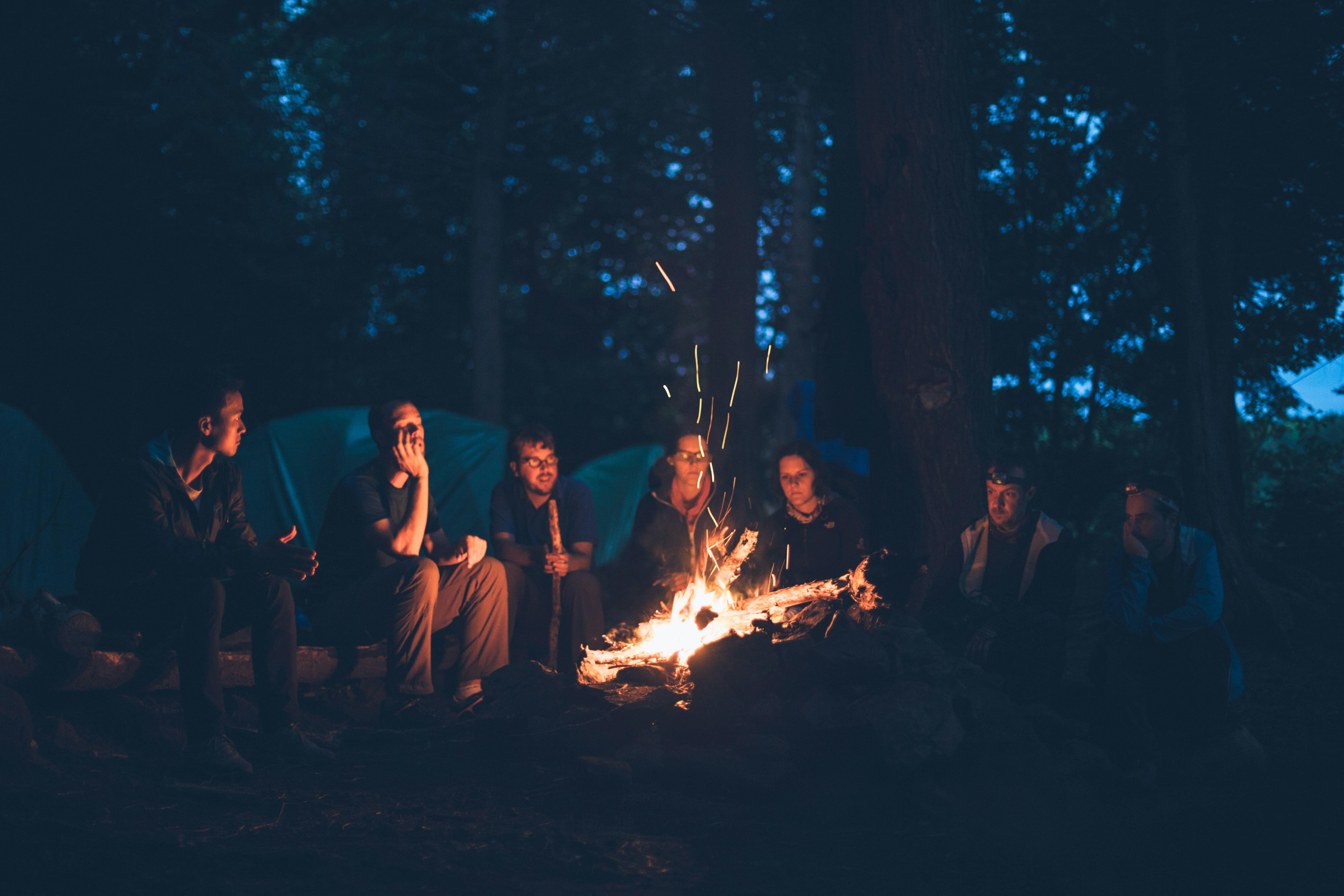 Teenagers sitting around a campfire in the dark