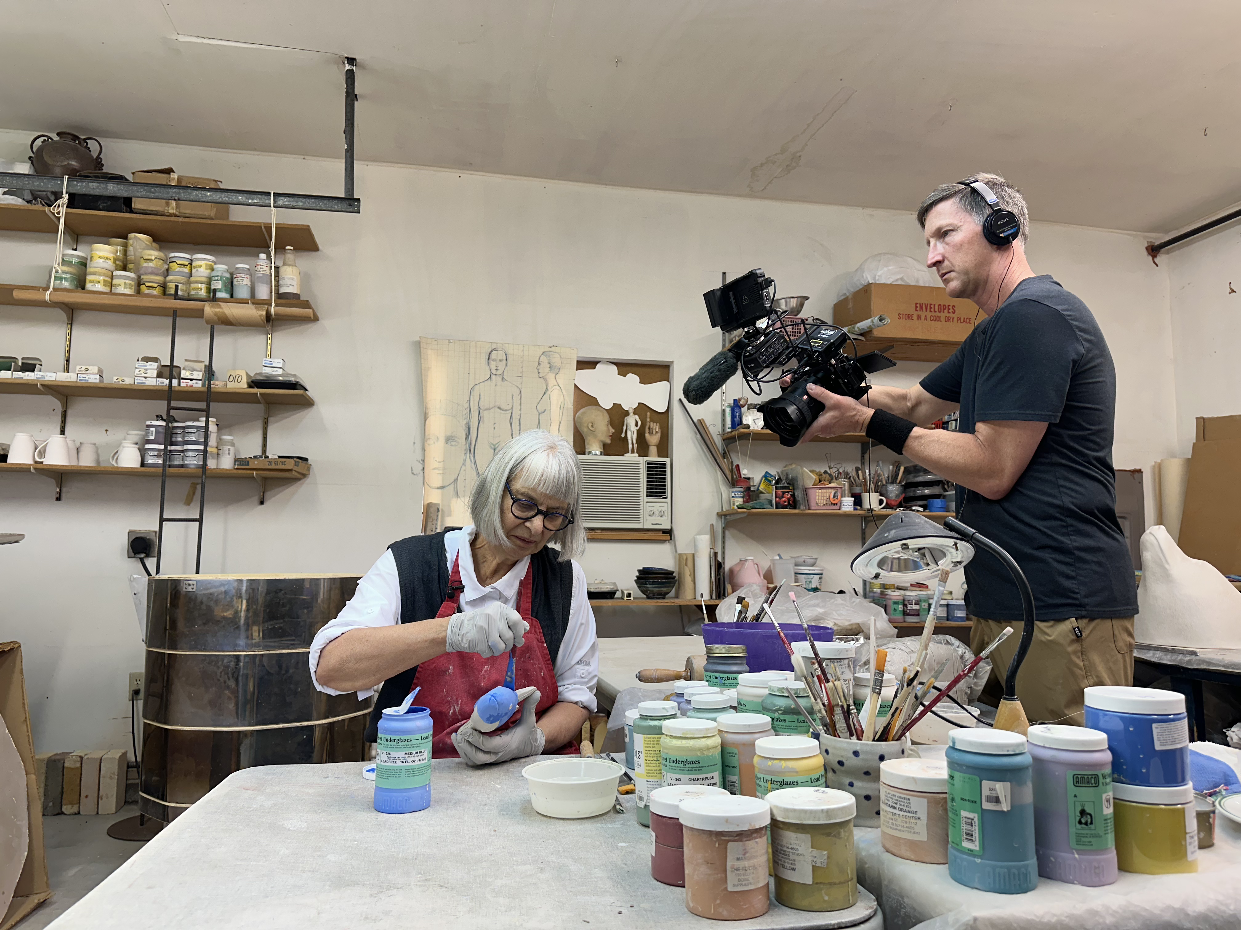 Videographer Troy Shreve filming Lysohir glazing a clay fish