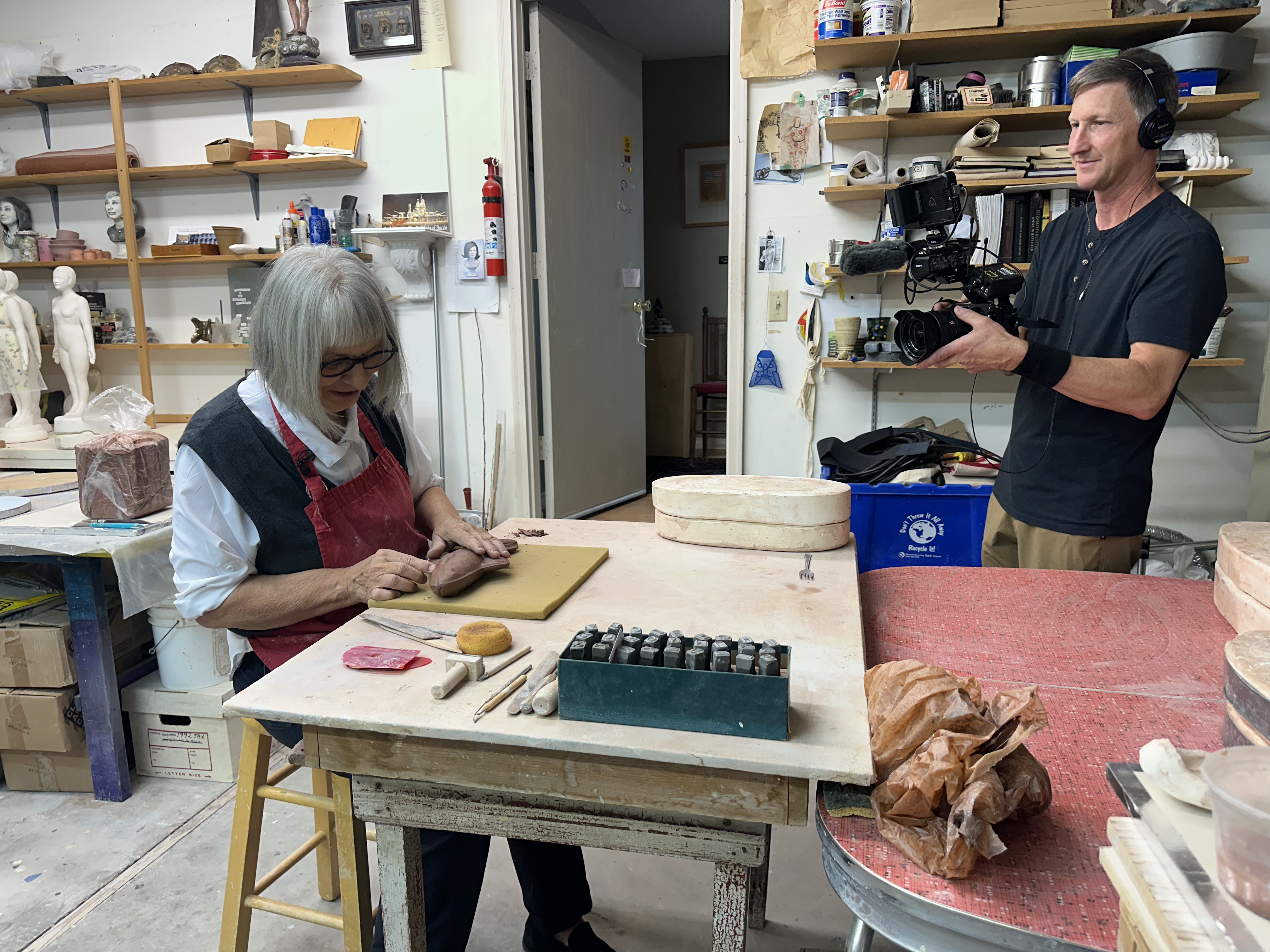 Videographer Troy Shreve filming Lysohir working on fish sculpture