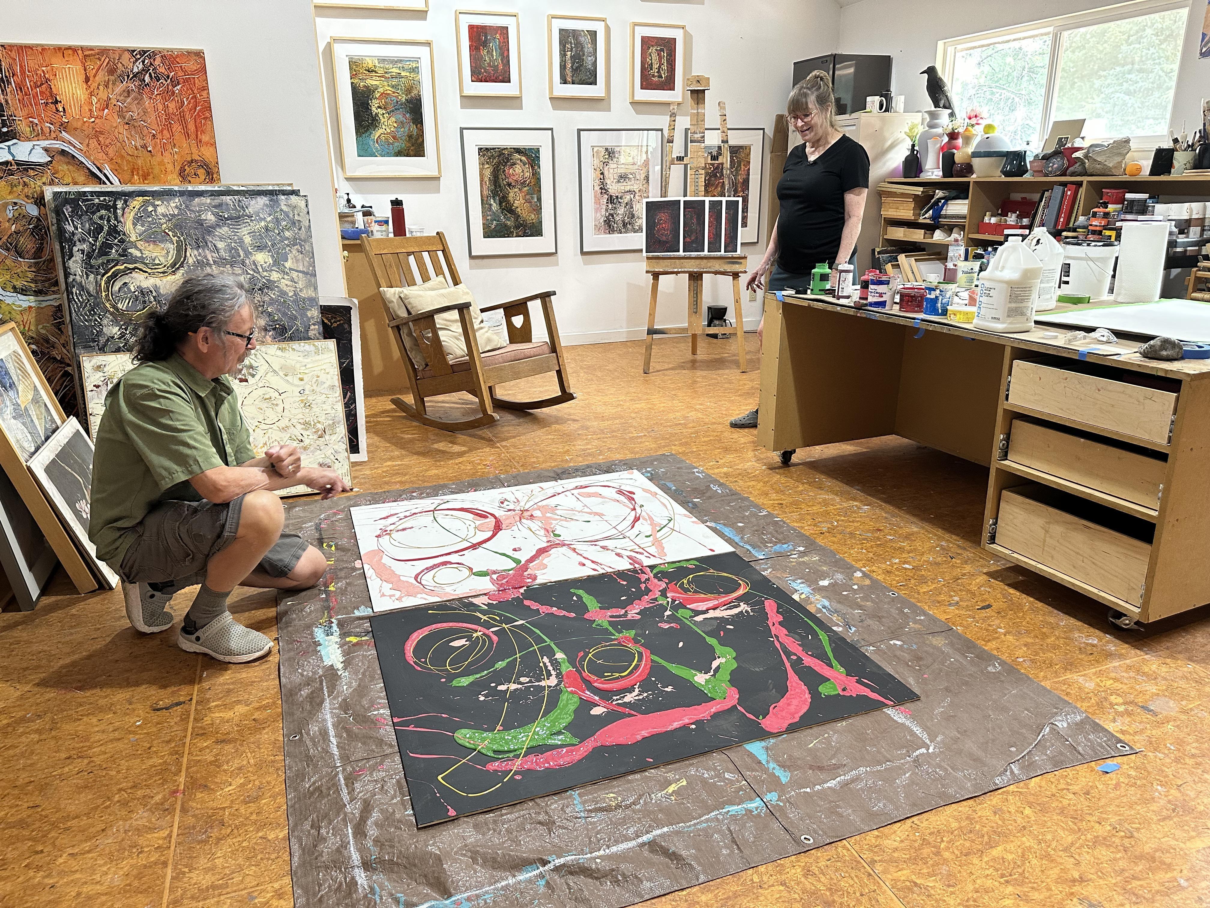Artist Lonnie Hutson looks at the start of a painting by his wife, artist Gail Siegel