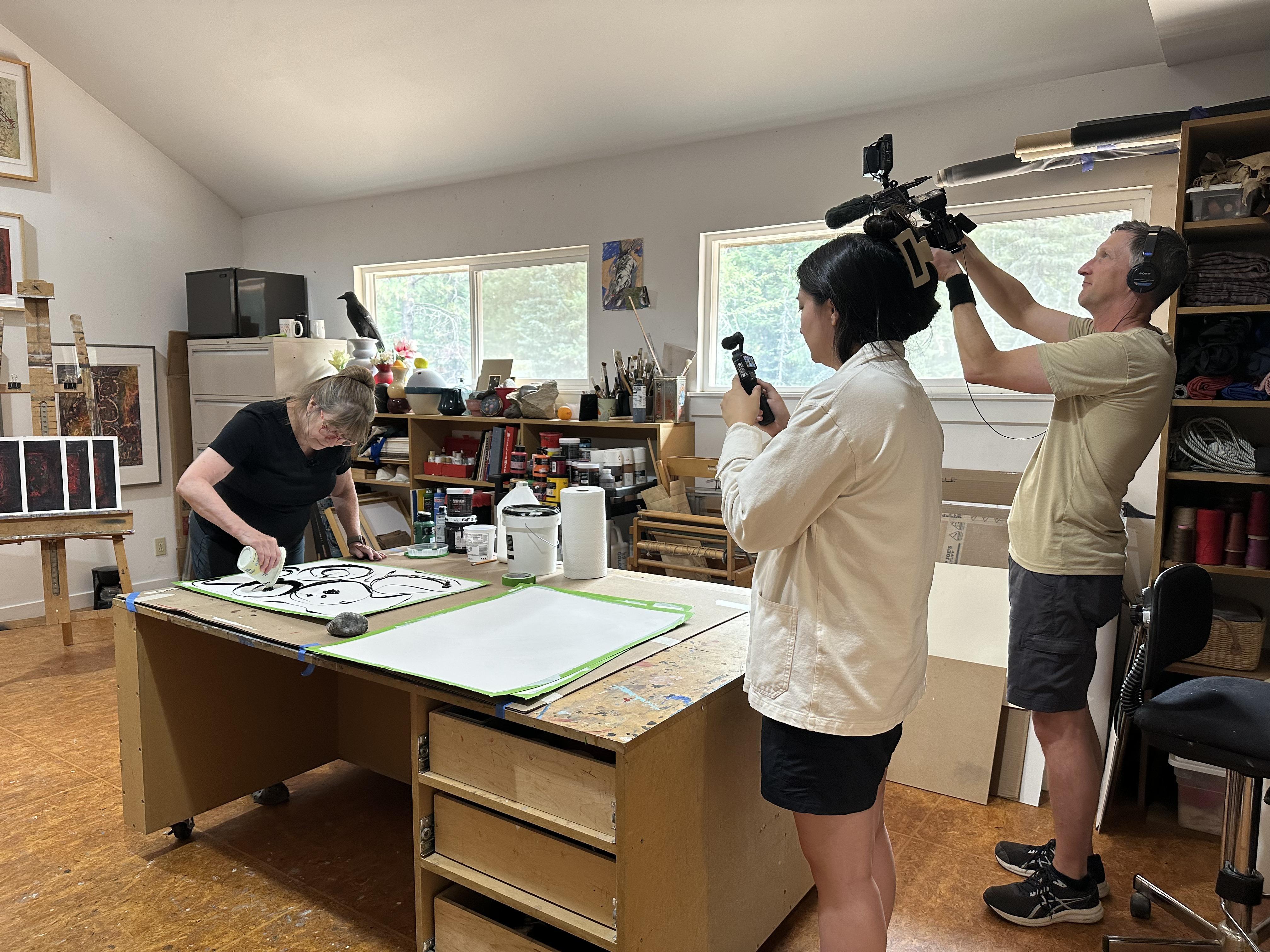 Associate Producer Hallie Maxwell and videographer Troy Shreve filming artist Gail Siegel