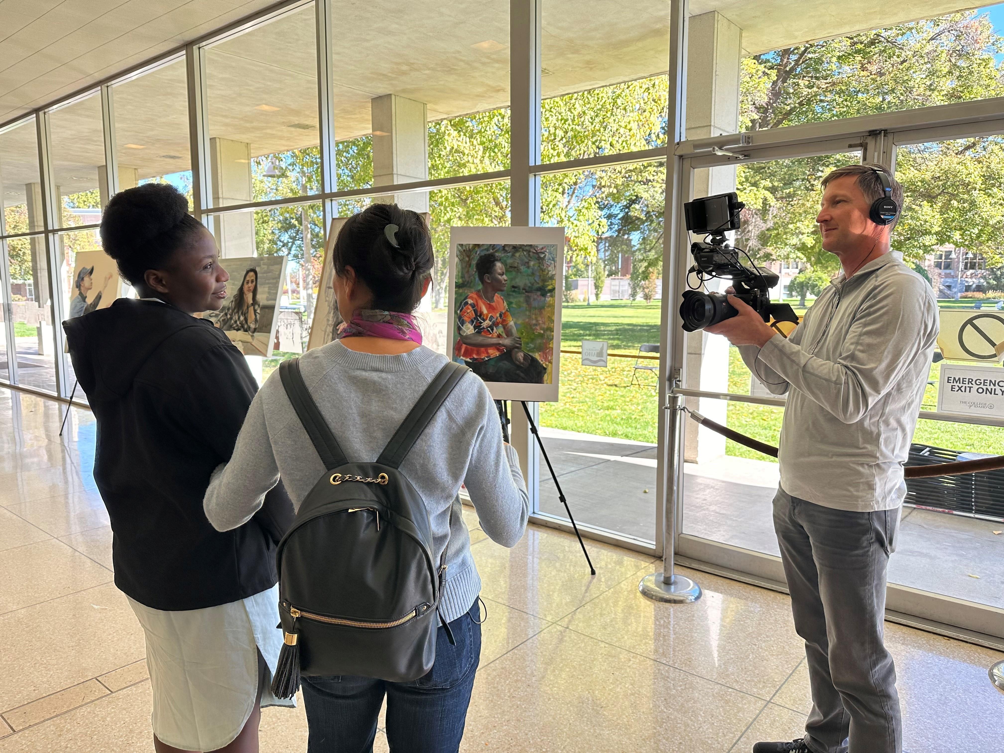 Videographer Troy Shreve filming the reveal of Yidan's painting