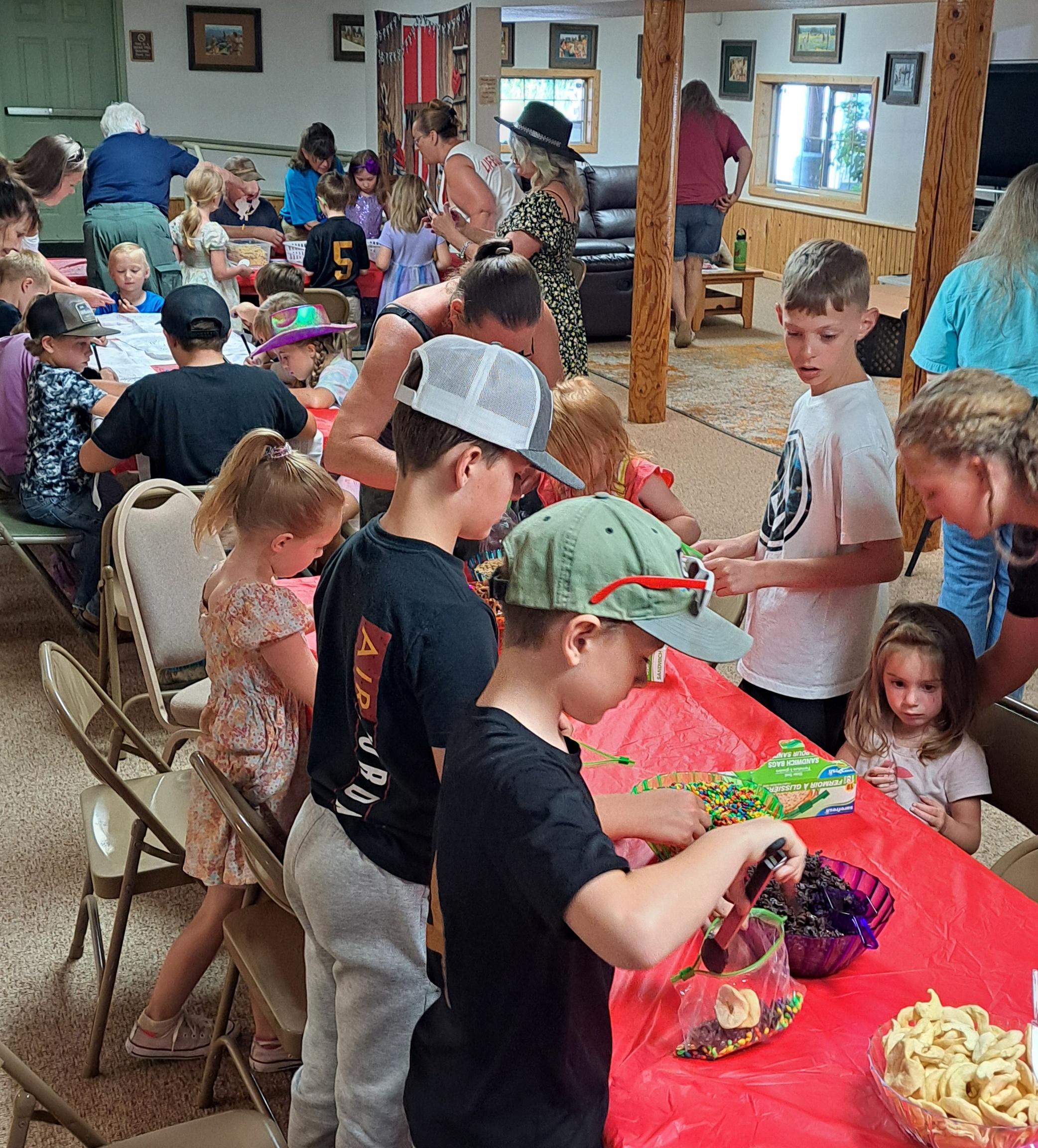 Kids gathered around a table doing crafts